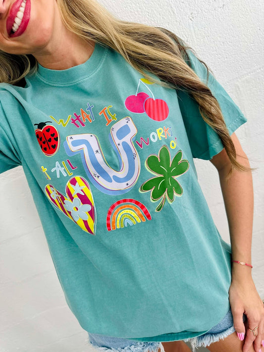 Person wearing a teal t-shirt with colorful graphics and text.
