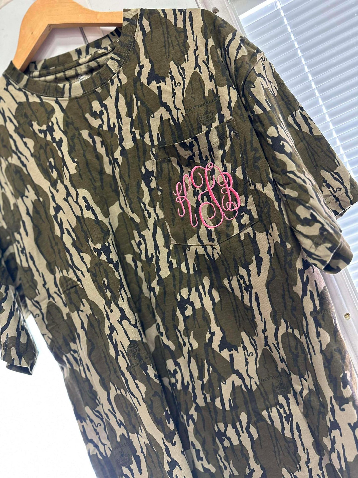 Camouflage dress with pink monogram on a hanger