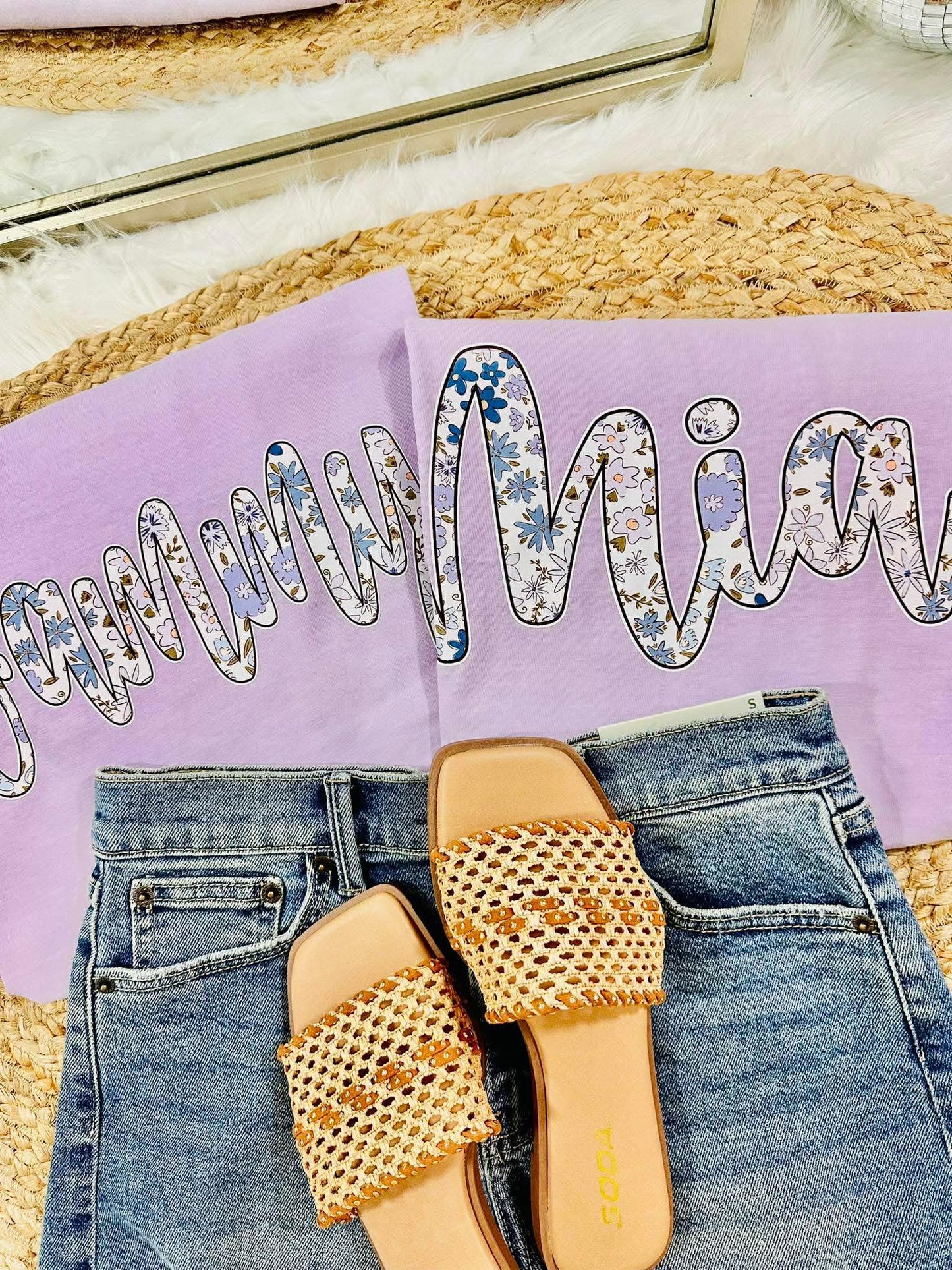 Pair of beaded sandals on jeans with a purple pillow and decorative text in the background